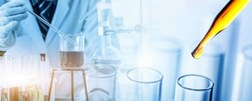 scientist holding flask with lab glassware and test tubes in chemical laboratory background, science laboratory research and development concept